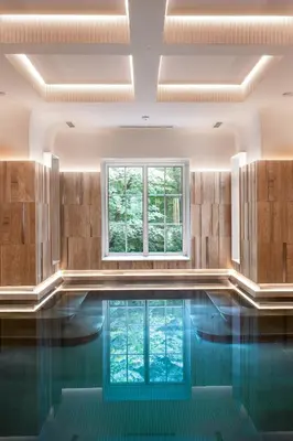 a swimming pool with a window in a room at Zinar Castle in Kraków