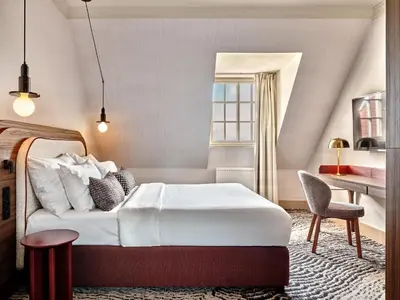 a hotel room with a bed and a desk at Zinar Castle in Kraków