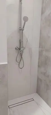 a shower with a glass door with a shower head at Juwel Apartments Kraków z widokiem na Wawel 44 in Kraków