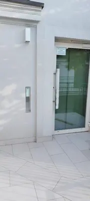 a white building with a glass door on it at Juwel Apartments Kraków z widokiem na Wawel 44 in Kraków