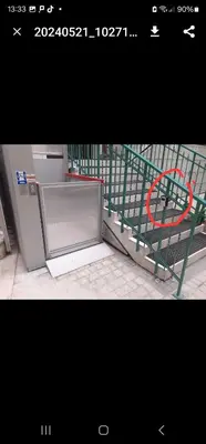 a green gate with a chair next to a refrigerator at Juwel Apartments Kraków z widokiem na Wawel 44 in Kraków
