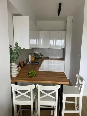 a kitchen with a wooden counter and white cabinets at APARTAMENT AMZOHA in Zator