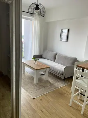a living room with a couch and a table at APARTAMENT AMZOHA in Zator