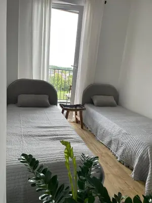 two twin beds in a room with a window at APARTAMENT AMZOHA in Zator