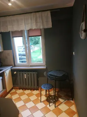 a kitchen with two chairs and a table and a window at FEIDUM quarters rooms in Trzebinia