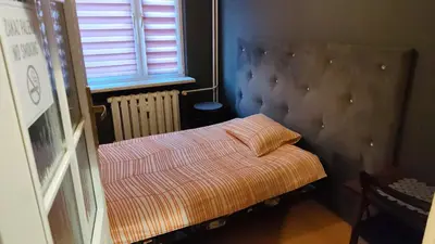 a bedroom with a bed and a desk and a chair at FEIDUM quarters rooms in Trzebinia