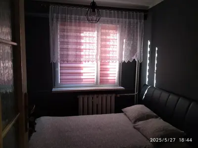 a bedroom with a bed and a table and chairs at FEIDUM quarters rooms in Trzebinia