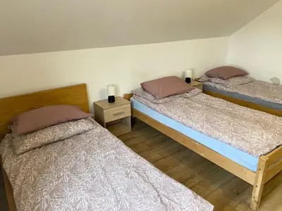 two twin beds in a room with two lamps at Noclegi Grojec in Grojec