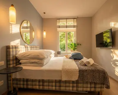 a bedroom with a bed and a mirror at City Lights Mostowa 6 in Kraków