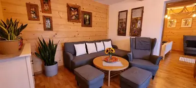 a living room with a couch and two chairs and a table at Apartamenty Siedlisko pod Aniołem in Zubrzyca Górna