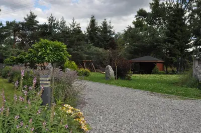 a garden with a gazebo in the background at Apartamenty Siedlisko pod Aniołem in Zubrzyca Górna
