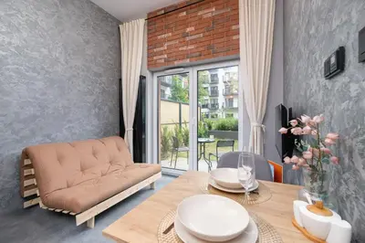 a living room with a couch and a table at Salsa Residence Pet-friendly by Noclegi Renters in Kraków