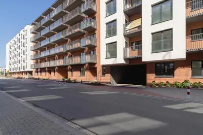 an empty street in front of an apartment building at Salsa Residence Pet-friendly by Noclegi Renters in Kraków