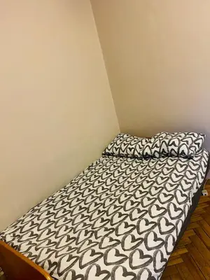 a bedroom with a bed with a black and white comforter at Retoryka in Kraków