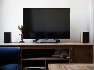 a flat screen tv sitting on a table with speakers at Stanislas Apartment in Kraków