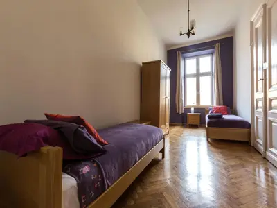 a bedroom with a bed and a window at Stanislas Apartment in Kraków