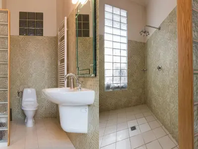 a bathroom with a sink and a toilet at Stanislas Apartment in Kraków