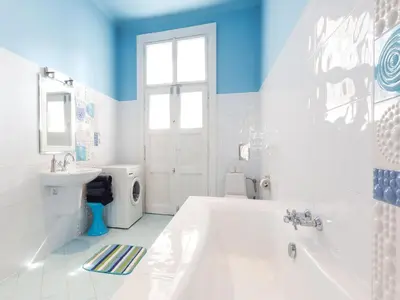 a white bathroom with a tub and a sink at Stanislas Apartment in Kraków