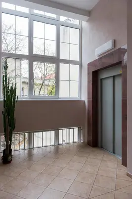 a large room with a fireplace and a door at Beauty of Krakow Apartment in Kraków
