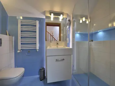 a bathroom with a sink and a toilet and a mirror at Beauty of Krakow Apartment in Kraków