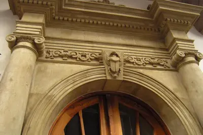 a building with a door with a statue above it at Beauty of Krakow Apartment in Kraków