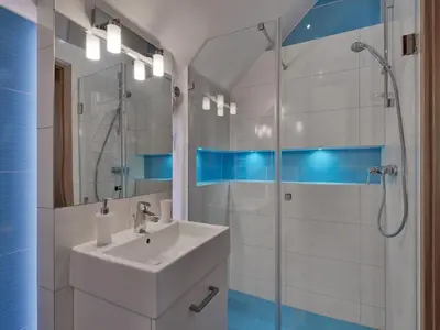 a white bathroom with a sink and a shower at Beauty of Krakow Apartment in Kraków