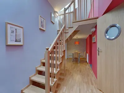 a staircase in a home with a red wall at Beauty of Krakow Apartment in Kraków