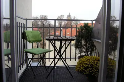 a balcony with a table and two chairs at Beauty of Krakow Studio in Kraków