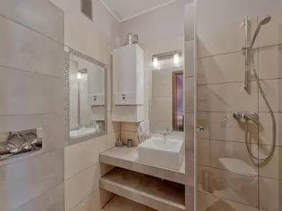 a white bathroom with a sink and a shower at Beauty of Krakow Studio in Kraków