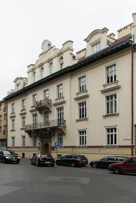a large building with cars parked in front of it at Beauty of Krakow Studio in Kraków