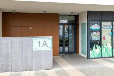 a building with a sign that says on it at Osiedle Avia Harmonious Apartment with Balcony Cracow by Renters Prestige in Kraków