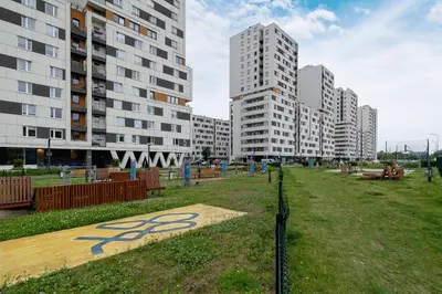 a park in a city with tall buildings at Osiedle Avia Harmonious Apartment with Balcony Cracow by Renters Prestige in Kraków
