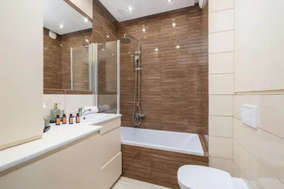 a bathroom with a shower and a toilet and a sink at Osiedle Avia Harmonious Apartment with Balcony Cracow by Renters Prestige in Kraków