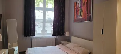 a bedroom with a bed and a window at TLC Apartments Cracow in Kraków