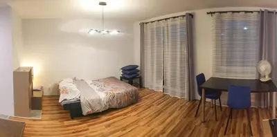 a bedroom with a bed and a desk and a table at Mini Apartament Kraków PN / Cracow NORTH z parkingiem in Kraków