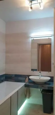 a bathroom with a sink and a mirror at Mini Apartament Kraków PN / Cracow NORTH z parkingiem in Kraków