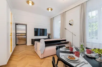 a living room with a couch and a table at Premium apartment in Parisian style in the heart of Old Krakow in Kraków