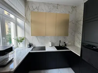 a kitchen with black and white marble walls and a sink at Premium apartment in Parisian style in the heart of Old Krakow in Kraków