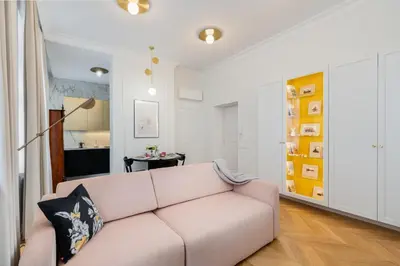 a living room with a pink couch at Premium apartment in Parisian style in the heart of Old Krakow in Kraków