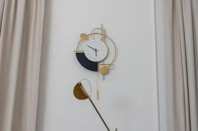 a clock hanging on a wall next to a window at Premium apartment in Parisian style in the heart of Old Krakow in Kraków