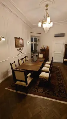 a dining room with a wooden table and chairs at Premium apartment in Parisian style in the heart of Old Krakow in Kraków