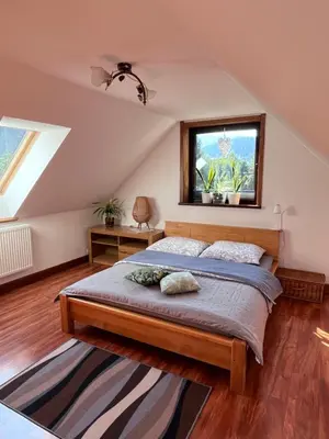 a bedroom with a bed and a window at Domek do wynajęcia in Poręba Wielka