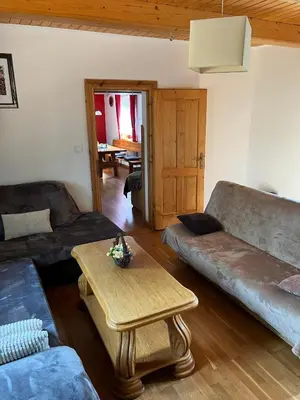 a living room with a couch and a table at Domek do wynajęcia in Poręba Wielka