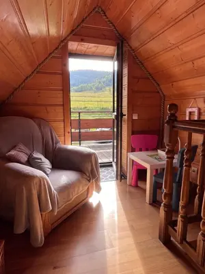 a couch in a room with a large window at Domek do wynajęcia in Poręba Wielka