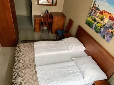 a bedroom with a white bed and a desk and a desk at Great apartment in the Old Town in Kraków