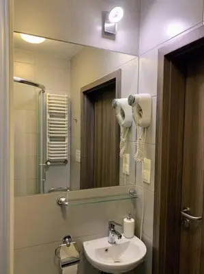 a bathroom with a sink and a mirror at Great apartment in the Old Town in Kraków