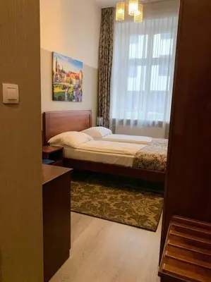 a hotel room with a bed and a window at Great apartment in the Old Town in Kraków