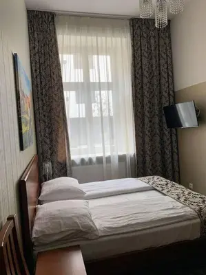 a bedroom with a bed in front of a window at Great apartment in the Old Town in Kraków