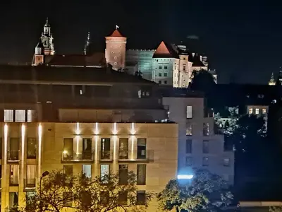 a view of a city skyline at night at Juwel Apartments Kraków z widokiem na Wawel ap 47 in Kraków