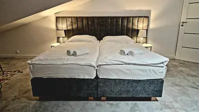 a bedroom with a large bed with towels on it at Juwel Apartments Kraków z widokiem na Wawel ap 47 in Kraków